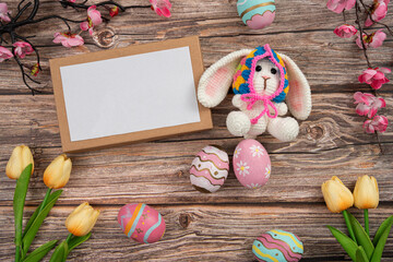 Cute Easter bunny with decorated eggs and blank card for greetings © itchaznong