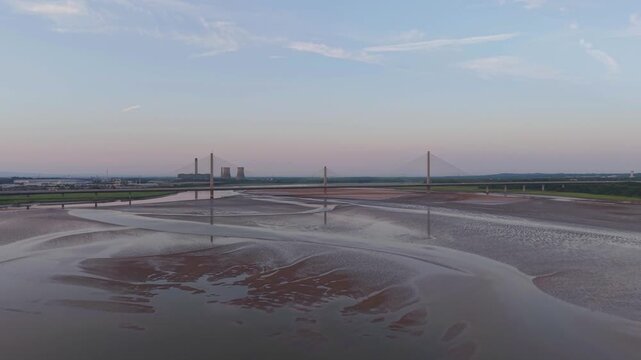 Liverpool, Merseyside, UK, June 19, 2025; Aerial 4K video footage of the Mersey Gateway toll bridge with stunning views over the River Mersey, Liverpool, UK.