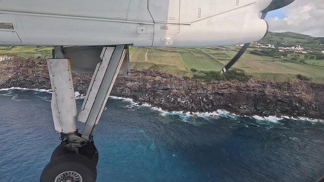 Landing approach over basalt cliffs near Horta, Faial Island, Azores, Portugal