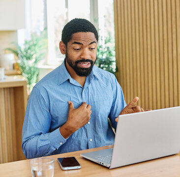 Portrait of a young blackman with laptop at home office