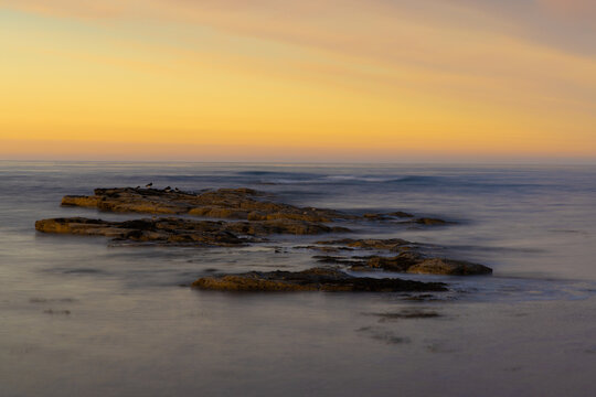 Sunset over Beadnell Bay at low tide,  Northumberland, England, UK.