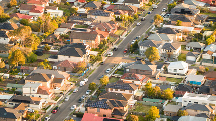 Aerial View of Australian Suburban Neighborhood with Solar Panel Rooftops at Golden Hour © red.io