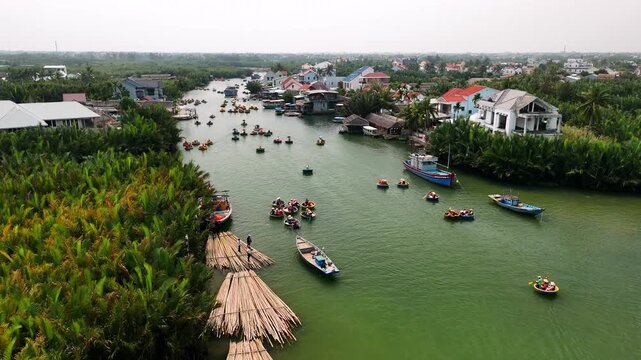 Tourists on basket boats on a river in hoi an, vietnam, surrounded by a coconut forest, Aerial view