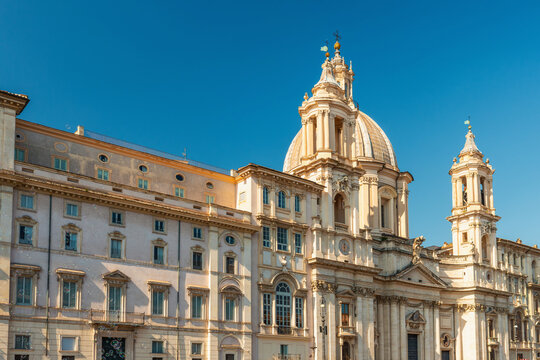 View of Sant Agnese in Agone baroque church with grand dome in Piazza Navona against blue sky, Rome city, Italy. Travel and tourism landmark in Europe
