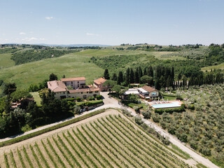 Naklejka premium Tuscan vineyard estate with pool on rolling hills