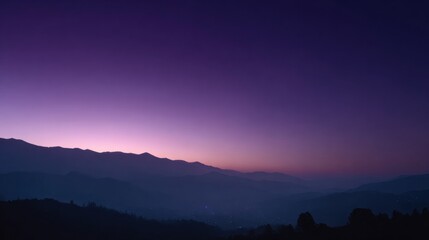 Fototapeta premium Winter Twilight Shows Purple and Blue Sky Above a Quiet Valley With Wide Open Space and Distant Mountains in View During Early Evening