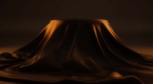 Cloth draped over object in dark room.