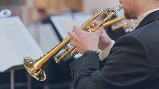 Musician playing trumpet in a classical orchestra concert