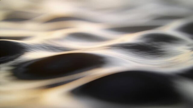 Shifting water surface forming small wavelets and crests as warm sunlight sliding across at sunset