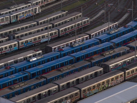 Aerial view of a multitude of trains parked on parallel tracks, displaying a spectrum of colors and patterns in the train yard, Roma, Lazio, Italy.