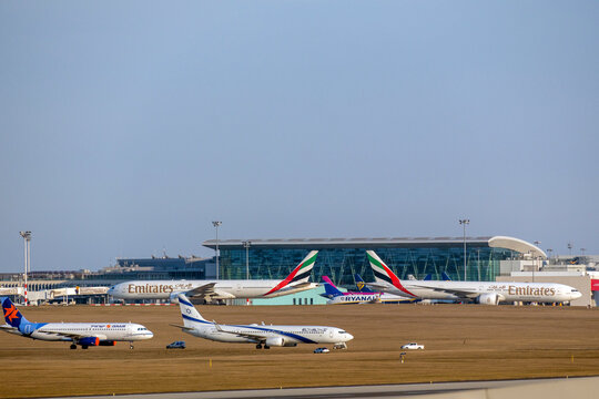 Various aircraft on the tarmac at Budapest International Airport during daylight hours