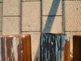 Commercial Photo of Weathered Brown Wood Bench Slats in Budapest, Top Down Close Up of Peeling Paint and Timber Grain on Cobblestone Pavement Background in Hungary, Urban Park Design and Maintenance