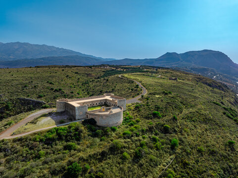 Aerial view of Fortezza of Intzedin stands proudly on a hill, its stone walls a stark contrast to the vibrant green landscape, Chania, Chania, Greece.