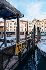 Fototapeta premium Water taxi station by the canal in a busy city during daytime hours