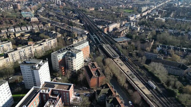 Aerial view of Kilburn Shoot Up Hill, featuring Brondesbury Park station and Windmill Court set against the distant London skyline.
