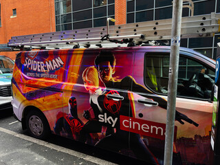 Fototapeta premium Manchester Spider Man promotional van with colorful Sky Cinema wrap and ladders on urban street