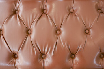 Naklejka premium Close up background of brown tufted leather sofa texture. luxurious vintage upholstery pattern creating comfortable and elegant feeling with classic diamond detail