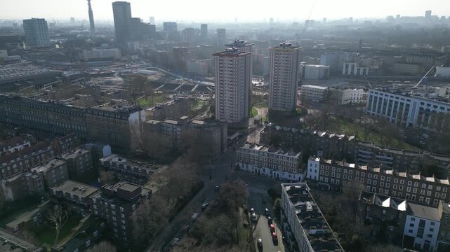 Aerial view over Londons Euston area, featuring residential towers, rail tracks, and the BT Tower, highlighting urban density.