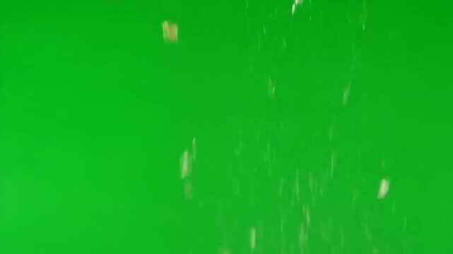 Grated parmesan cheese falling in slow motion against a bright green screen, perfect for culinary projects. This footage is ideal for food-related content, cooking shows, or recipe videos.