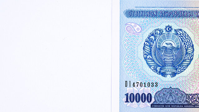 A 2017 banknote of 10000 Uzbek soums. The obverse depicts the state emblem. The reverse side of the banknote features an image of the Senate building in Tashkent.