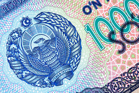 A 2017 banknote of 10000 Uzbek soums. The obverse depicts the state emblem. The reverse side of the banknote features an image of the Senate building in Tashkent.