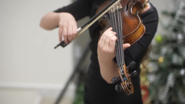 The Girl plays and trains the violin at a music school. A child's violin lesson. High quality video