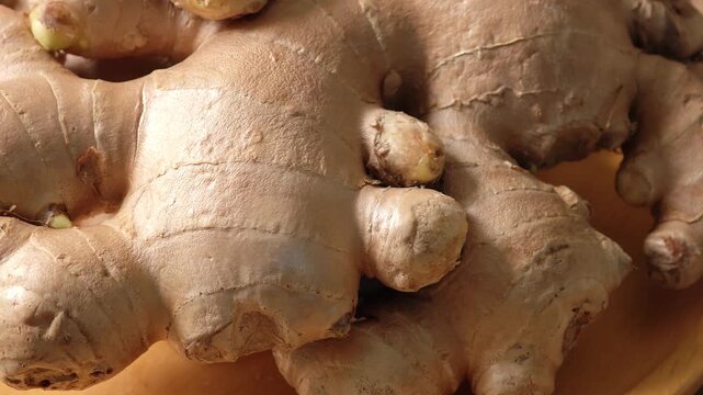 Fresh ginger in a wooden plate.