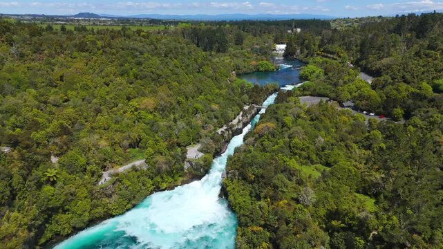 Aerial: Huka Falls on Waikato River during the day near Lake Taupo, New Zealand, reveal drone shot