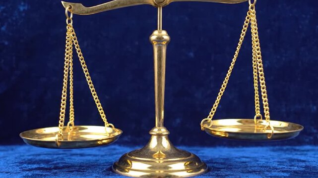 A shiny golden balance scale stands prominently against a deep blue background.