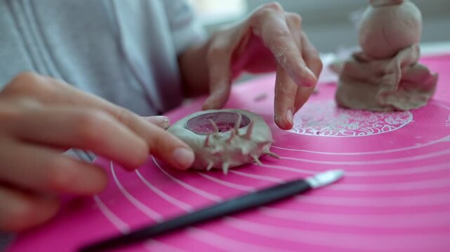 Preparing dumpling shells with delicate fingertip techniques in sunlight