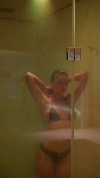 Elegant woman enjoys private spa with gentle lighting and steam