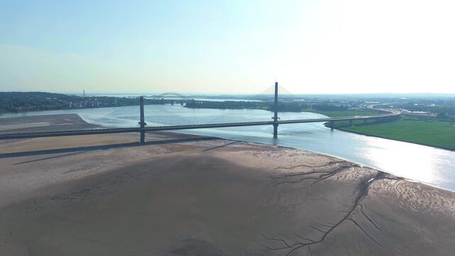 Liverpool, Merseyside, UK, June 19, 2025; Aerial 4K video footage of the Mersey Gateway toll bridge with stunning views over the River Mersey, Liverpool, UK.
