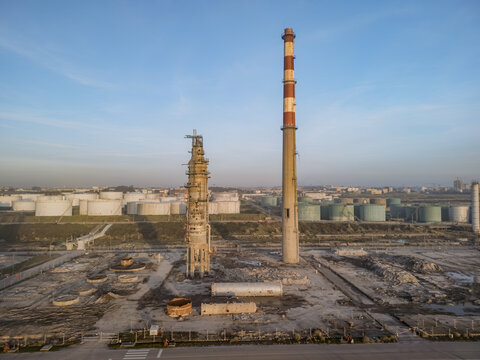 Aerial view of the decaying industrial landscape with towering smokestacks piercing the skyline, a stark contrast against the rows of storage tanks, Matosinhos, Porto District, Portugal.