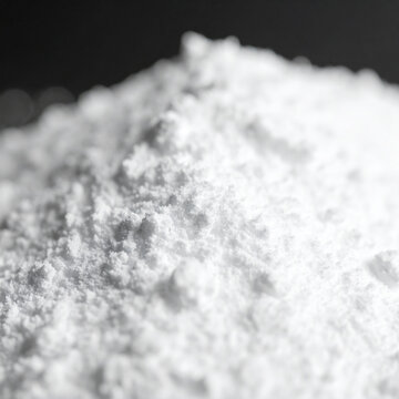 White titanium dioxide powder heap, blurred background. Calcium carbonate, magnesium or zinc oxide