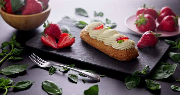 French Eclair Delicious pastry With Fresh Strawberries and Whipped Cream food presentation cinematic video