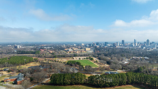 Downtown Raleigh skyline from Dorothea Dix Park with open fields and trees in foreground.