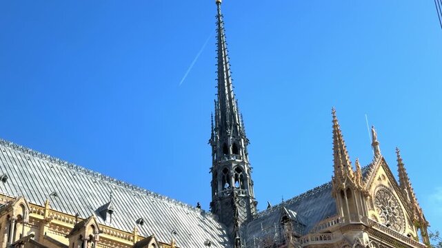 The new fleche of Notre Dame de Paris cathedral against a blue sky in Paris, France
