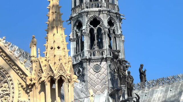 A close-up of the statues at the base of the newly completed spire of Notre Dame de Paris cathedral in Paris, France