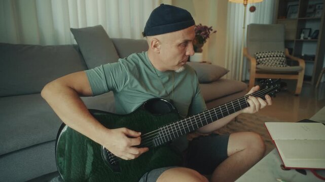 Man Adjusting Guitar Comfortably Indoors. Casual Musician Finetuning Strings In Relaxed Environment