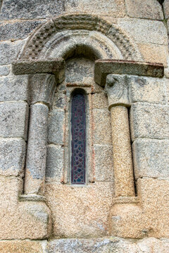 Time-honored 12th-century Romanesque window of the San Marti&ntilde;o de Agudelo church apse with granite columns and semicircular arch, Barro, Pontevedra, Spain