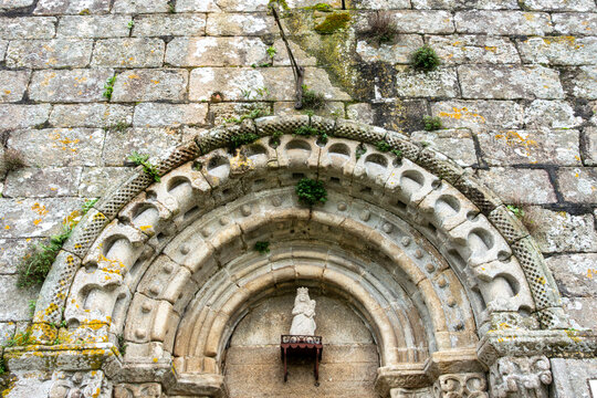 Intricate 12th-century Romanesque main portal of Santa Maria de Herbon church featuring decorated archivolts and checky molding, Padron, Galicia, Spain