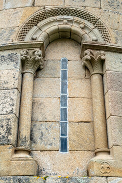 Graceful 12th-century Romanesque window of the Santa Maria de Herbon church apse with checky archivolts and carved stone capitals, Padron, Galicia, Spain