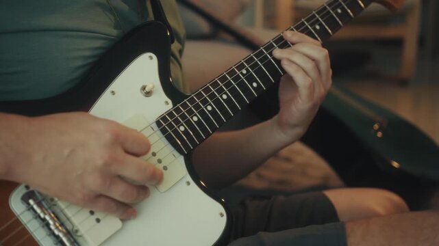 Closeup Of Guitar String Picking. Close Shot Of Fingers Pressing Guitar Frets With Concentration