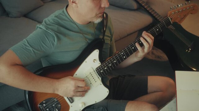 Closeup Of Guitar String Picking. Close Shot Of Fingers Pressing Guitar Frets With Concentration