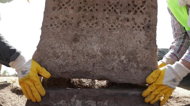 Lifting a historical monumental tombstone with a crane during the restoration project at the Ahlat Seljuk Cemetery, the largest Turkish-Islamic cemetery in the world, located in Bitlis, Turkey.