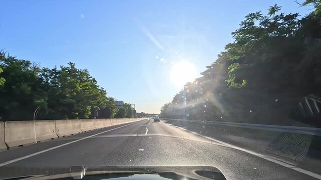 Driving on D1 motorway in Western Slovakia with low sun glare