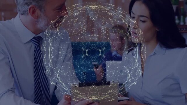 Network sphere dissolving revealing man holding tablet while woman pointing reviewing business data