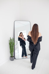 young woman holding baby in her arms and looking in the mirror