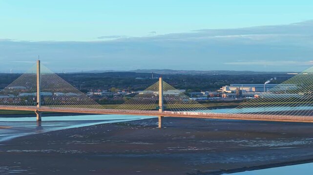 Liverpool, Merseyside, UK, June 19, 2025; Aerial 4K video footage of the Mersey Gateway toll bridge with stunning views over the River Mersey, Liverpool, UK.