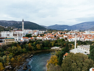 Naklejka premium Aerial view of the city of Mostar and Neretva river, old Bridge, Koski Mehmed Pasha Mosque. Bosnia and Herzegovina .